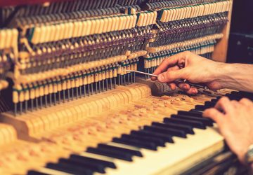Expert hands fine-tuning piano strings in Adelaide