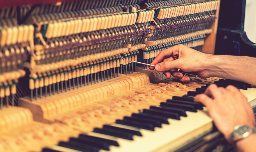 Expert hands fine-tuning piano strings in Adelaide